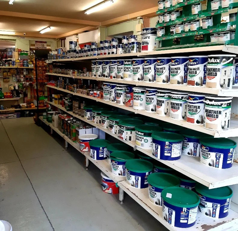 The paint aisle, shelves of Dulux Weathershield tins and tubs