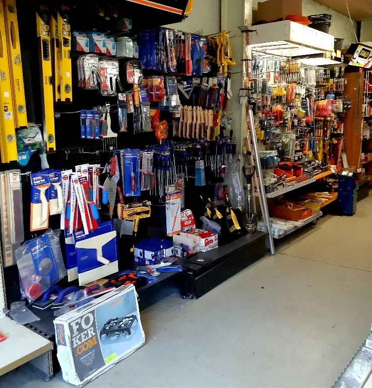 Hand tools on the pegboard: Stanley levels, trowels, brushes and screwdrivers