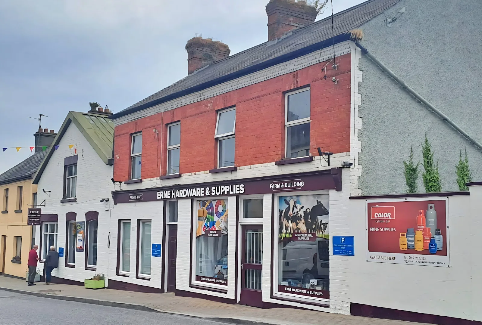 Erne Hardware & Supplies on Lower Bridge Street, Belturbet: red-brick shopfront with a maroon fascia, Paints & DIY and Farm & Building signs, and the Calor gas board on the side wall